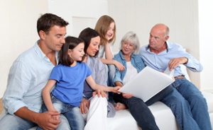 3-generation family looking at photo album-1