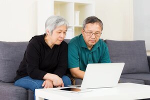 Asian old couple using laptop