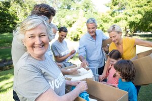 Happy volunteer family separating donations stuffs on a sunny day