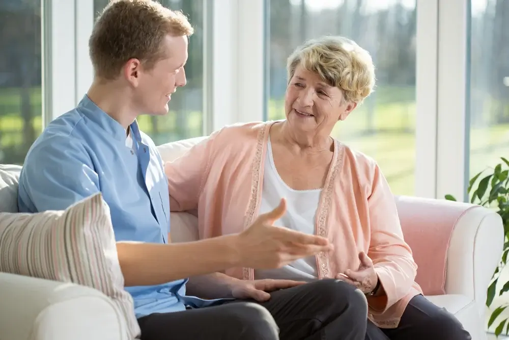 Male nurse and senior woman sitting on the couch-1 (1)