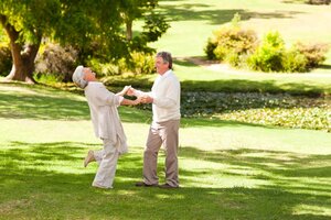 Mature couple dancing in the park