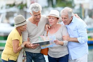 Senior tourists using tablet on visiting journey