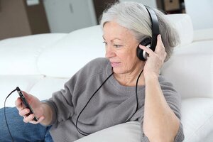 Senior woman listening to music with headphones