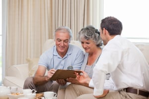Seniors speaking with planner at home