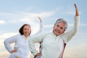 Elder women in a stretching class outdoors fitness concepts