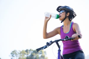 Woman cycling in a forest in the countryside