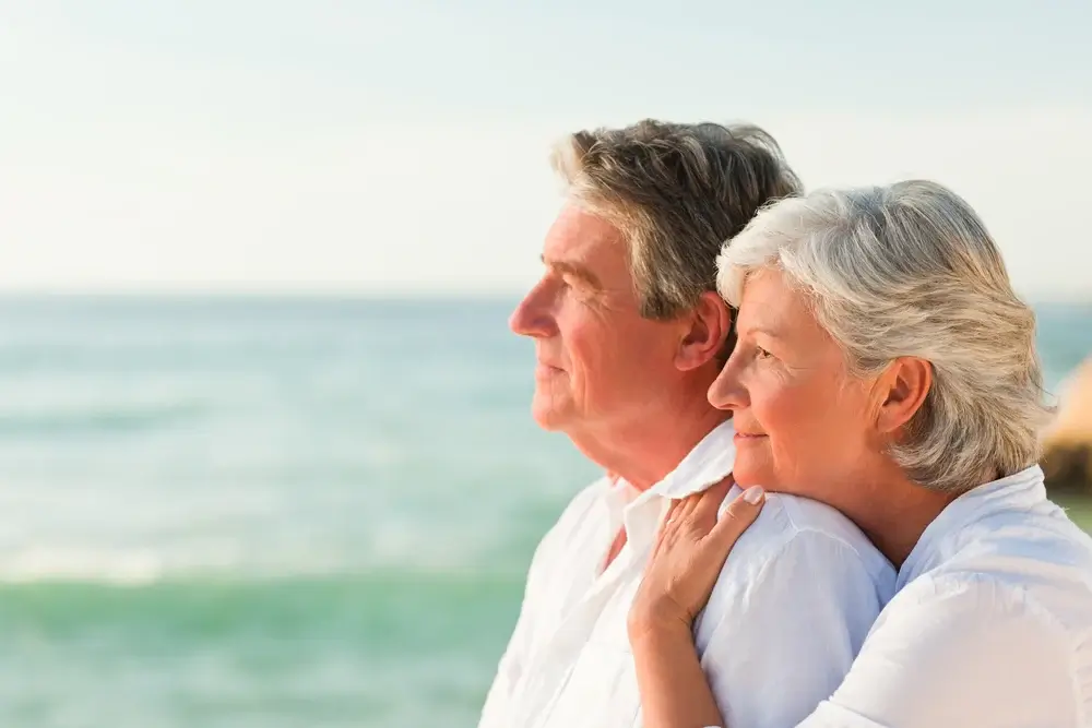 Woman hugging her husband at the beach (1)