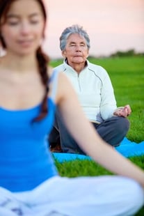 Women practicing yoga exercises outdoors _ fitness concepts
