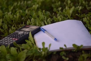 budgeting notebook, pen, and calculator