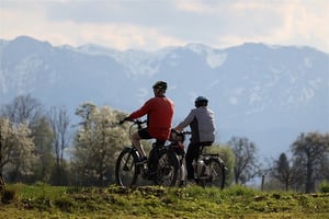 older couple biking together outdoors 