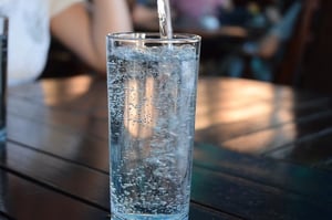 pouring water into a glass-hydration
