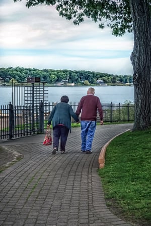 older couple walking in park