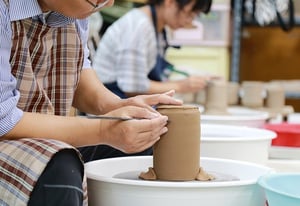 senior man practicing pottery