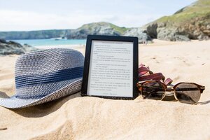 ebook tablet reader on the beach in sand