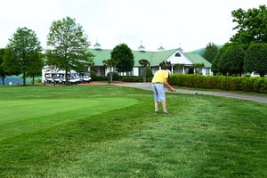 senior man golfing chipping off the green