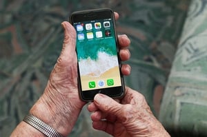 older adult holding mobile phone