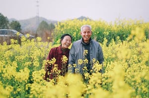 happy older couple in field outdoors