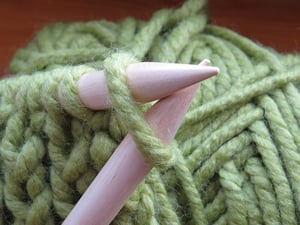 knitting needles and green yarn