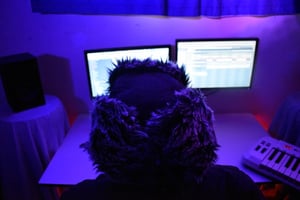 Computer screen blue light, person sitting in front of computer screen at night