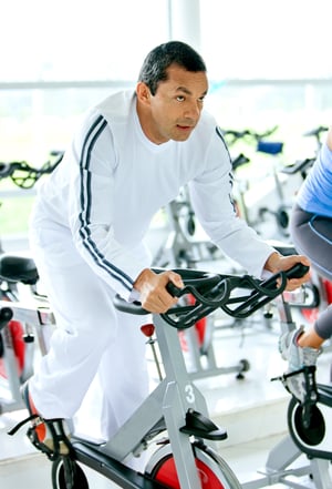 man at the gym doing cardio exercise on spin bike