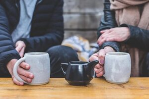 man and woman having tea together