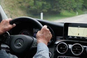 older gentleman driving with built-in gps