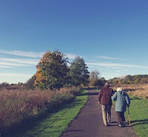 senior couple walking on path outdoors