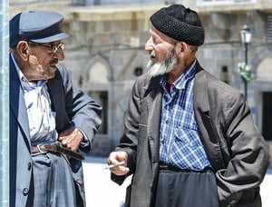 older man smoking cigarette outside