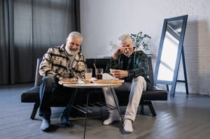 older male friends enjoying time together over a meal