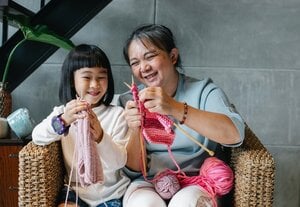 grandmother and child knitting together