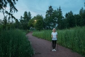 older woman walking outdoors 