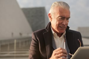 stressed man looking at tablet