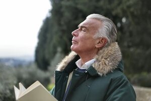 man deeply breathing outdoors