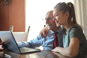 older man and daughter researching communities together online