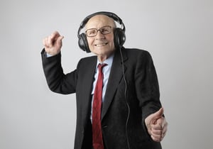 Older man dancing to music with headphones