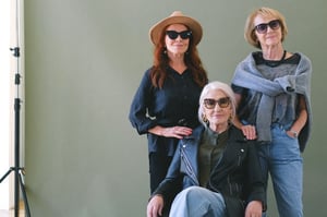 three older women posing together with sunglasses