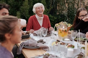 grandmother eating outdoors with family 
