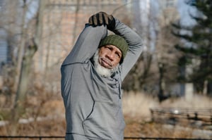 older man stretching before exercise outdoors