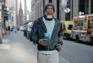 older man walking in sweats with water bottle