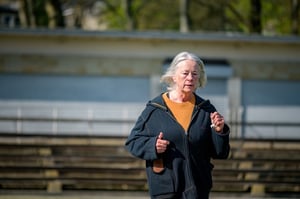 older woman running outside in a park exercising