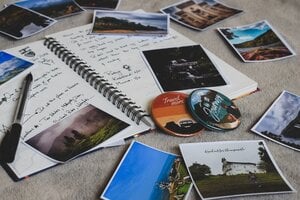 photos on floor making a scrapbook