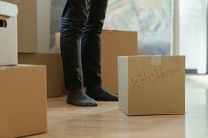 standing next to moving boxes