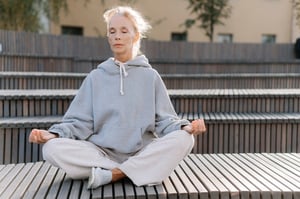 older woman meditation outdoors
