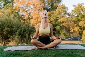 senior woman meditating outdoors