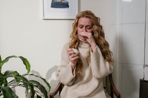 woman suffering from allergies indoors