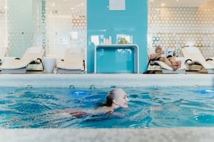 older woman swimming laps in pool