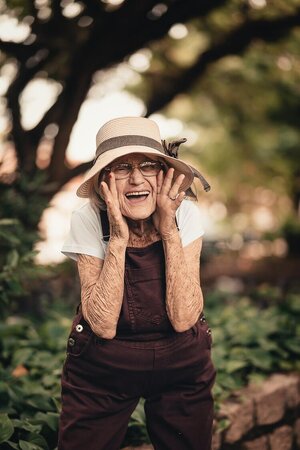 older woman outdoors laughing out loud smiling