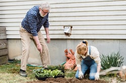 older couple gardening together outside