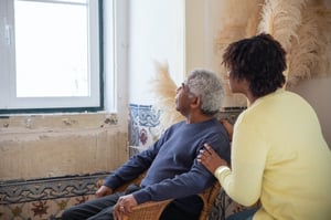 older man sitting with daughter looking out the window 