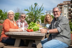 two senior couple eating healthy vegetables outdoors